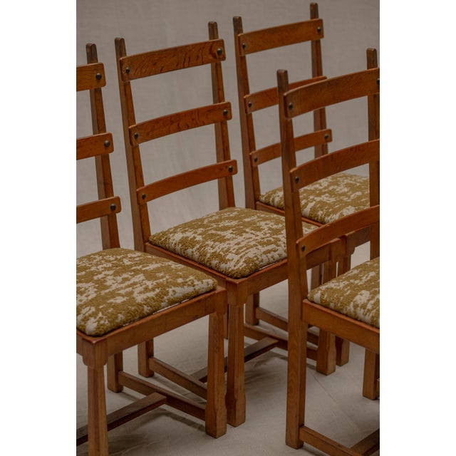 A striking vintage set of six Brutalist dining chairs from the 1960s, crafted in solid oak and defined by their expressive...