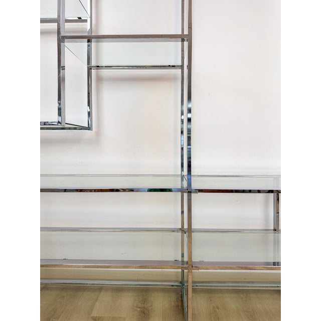 This stunning vintage Milo Baughman style chrome and glass etagere is a rare and spectacular display piece that makes an...
