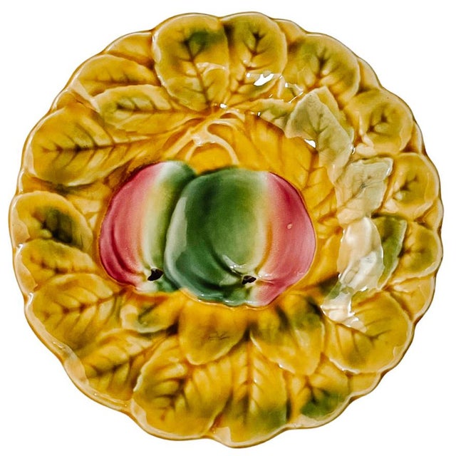 A set of five classic French faience plates with fruit motifs (grapes, pears, cherries, plums and apples) by Sarreguemines...