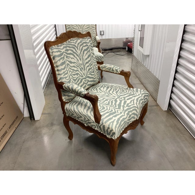 This is an exceptional pair of French walnut fauteuils, or side-chairs. With exquisitely carved frames, these chairs were...