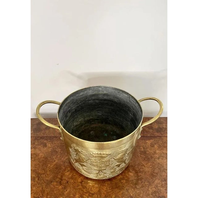 Quality antique Victorian circular brass coal bucket having a quality antique Victorian brass coal bucket decorated to the...
