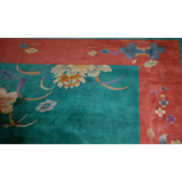 Handmade antique Art Deco Chinese rug in green and orange colors. The rug is from the beginning of 20th century in...