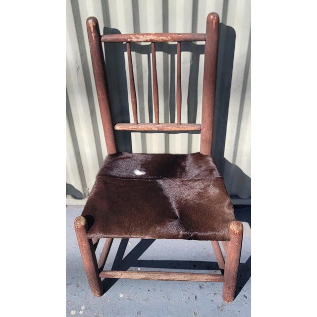19Thc Original Red Painted country child's chair with cow skin seat.The condition is very good