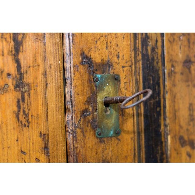This unique and antique one door Baltic pine armoire or wardrobe was handcrafted in late 19th century. On the armoire is...