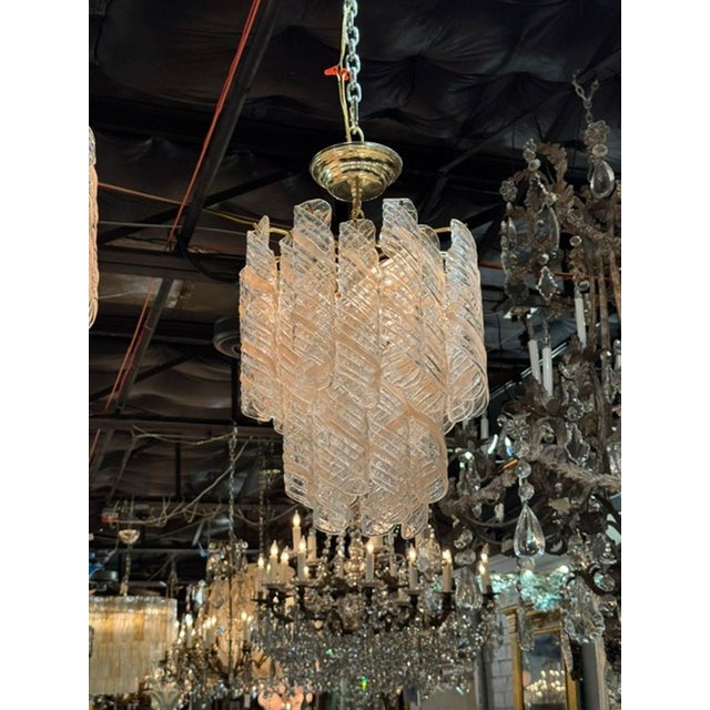 The Vintage Murano Clear and Blush Spiral Chandelier is a stunning and unique piece of lighting. The intricate spiral...