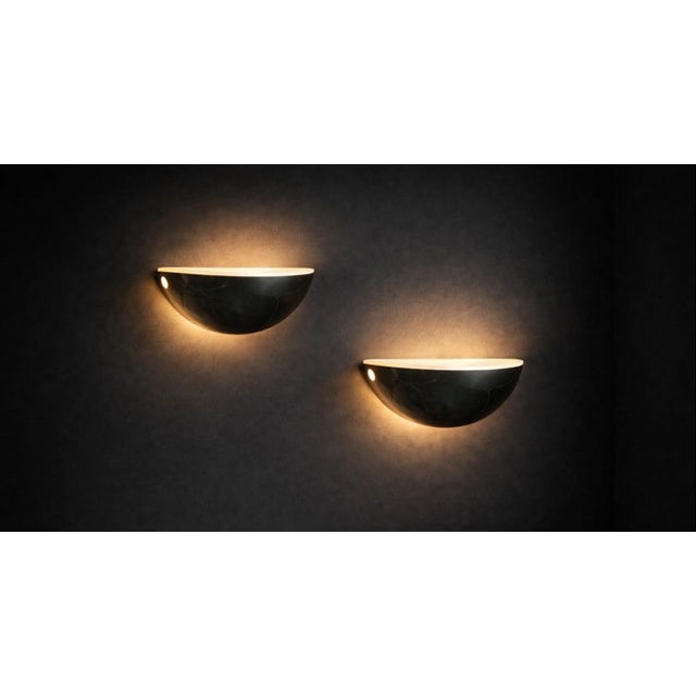 The brass "Quarto Wall Lamps" are a design icon. Introduced in 1973, they remain a highly regarded design element for...