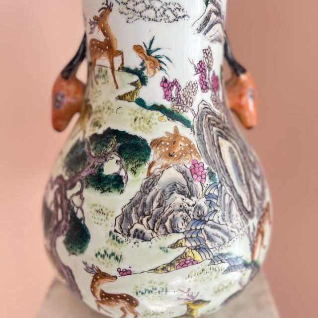 This is a beautiful large Chinese vase that is hand-painted in the “100 deer” motif, and displays scenic landscapes filled...