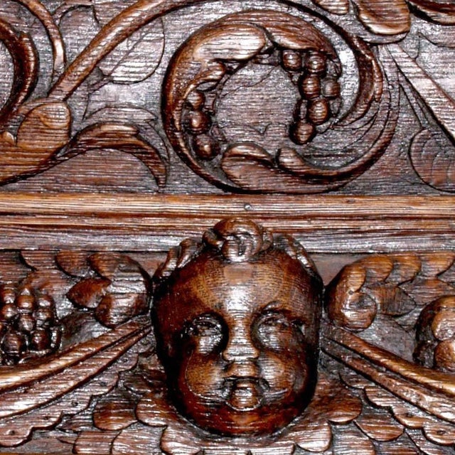 This valuable ancient noble 16th century Ligurian carved oak and chestnut Bambocci credenza features a display cabinet. It...