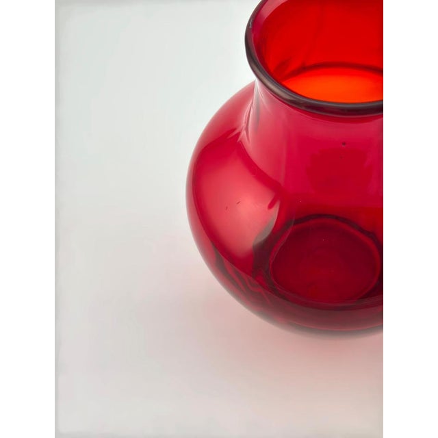 A rare variation of mid-century British art glass, this ruby red glass vase was made by Whitefriars Glass, England, circa...