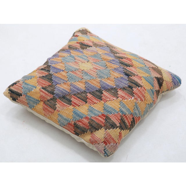 A one-of-a-kind handwoven Afghan wool kilim accent pillow featuring harlequin diamond grid. Cut and sewn by hand from a...