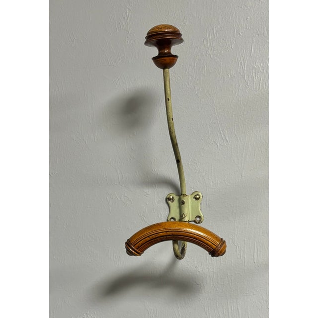 A charming vintage French wall-mounted coat and hat hook that blends warm wood with beautifully aged metal in a way that...
