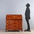 Roman-style drop-leaf chest, crafted in the mid-20th century, features an elegant walnut veneer with maple inlays and trim...