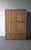 This is a 19th Century, rustic European two-door cabinet crafted from solid English pine. Rich in character, the worn...