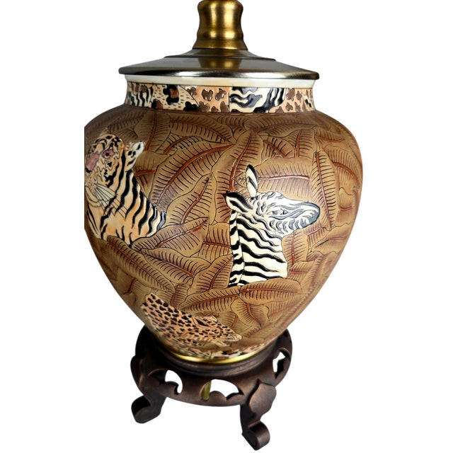 A matched pair of vintage ceramic ginger jar table lamps by Oriental Accent, hand-painted with tiger, zebra, and leopard...
