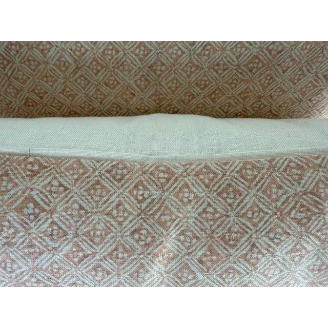 A pair of decorative pillows crafted from a finely printed linen textile with a repeating geometric diamond motif in...