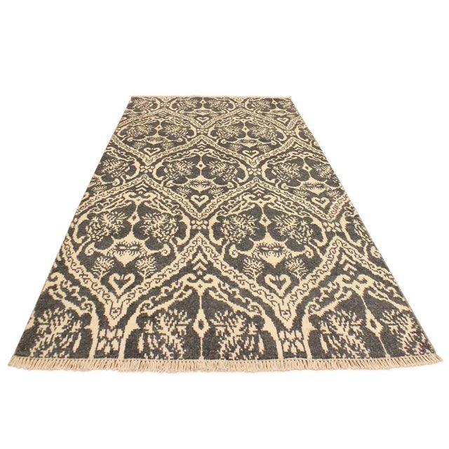 This elegant hand knotted rug features a modern fusion of beauty, with its interlocking geometric and minimalist pattern....