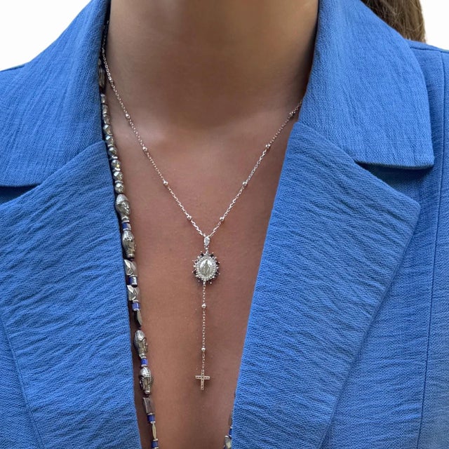 Discover a blend of spiritual significance and luxurious style with Sapphire & Diamond Virgin Mary & Cross Pendant...