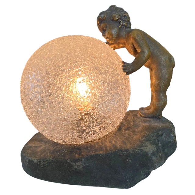 Baby Bubble lamp, cast bronze in the manner of Aristide de Ranieri. Naked toddler fascinated by a crystal bubble or...