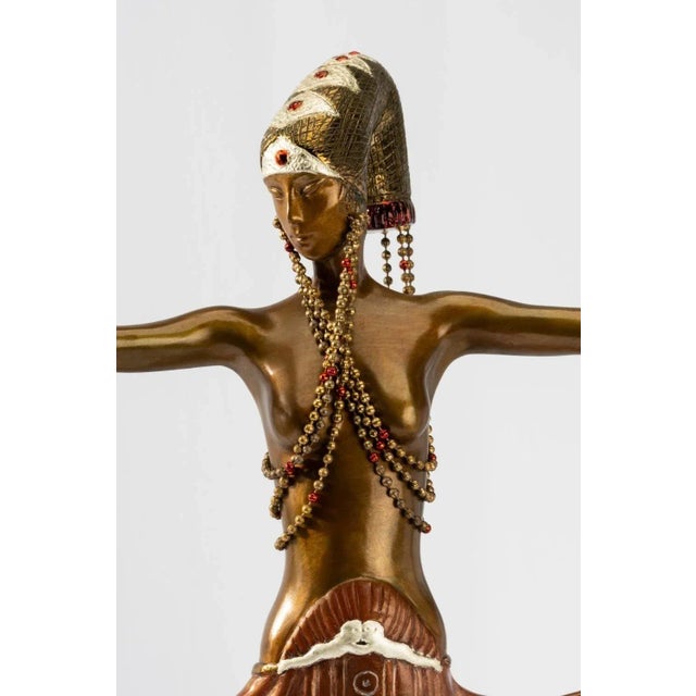 "Venus" sculpture by Erté made with cold-painted bronze depicting a female in elegant couture with bright colors and...