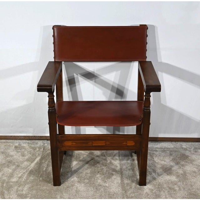 This walnut armchair, with its graphic, rudimentary lines, is in the spirit of the Middle Ages. The seat and backrest...