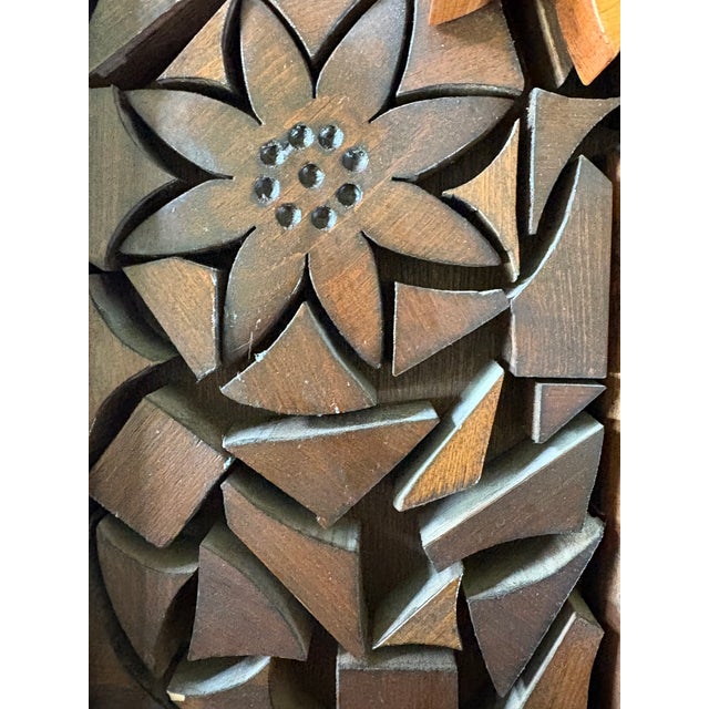 A wood carved panel that feels reminiscent of the art by Louise Nevelson.