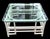 This is a white Chinese Chippendale style rattan square coffee table by Feeks Reed. It has a glass top and is in very good...