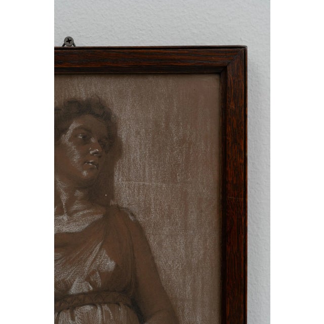 This early 20th-century Belgian painting captures the elegance and grace of a woman dressed in the fashion of the era. The...