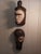 Striking and visually commanding pair of vintage hand carved African masks displaying stylistic influences associated with...