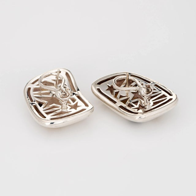 Stylish Michael Bondanza star earrings crafted in sterling silver & 18 karat yellow gold (circa 2000s). The earrings...