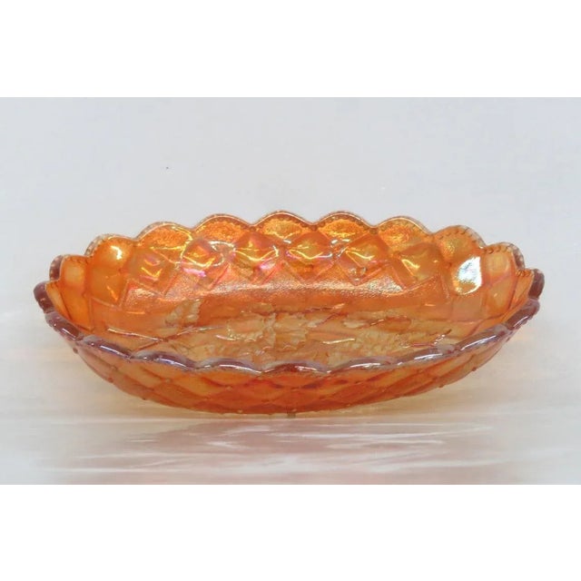 This Candy Dish is made of glass. We believed it made by Imperial Glass because of its design but it is not signed or...