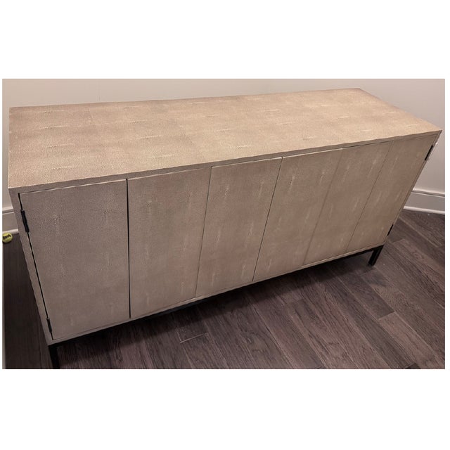 Credenza finished in warm Hudson Beige shagreen with brass hardware. This substantial statement piece with generous...