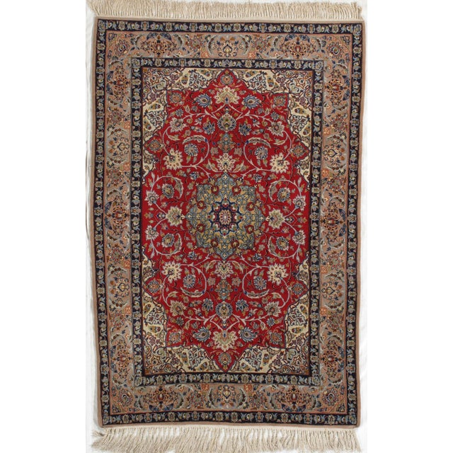 Vintage hand-knotted Persian Isfahan (Esfahan) wool rug on a silk foundation, featuring a red field with a central...