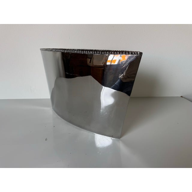 A striking piece from renowned designer Michael Aram, this sculptural vase from the Molte Series features a sleek, curved...