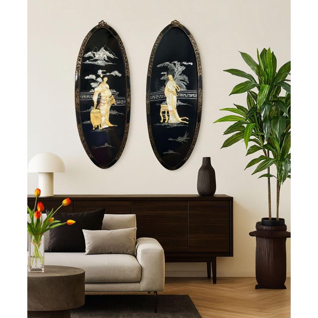 Offering a pair of vintage Chinese black lacquered wood wall plaques, circa Mid 20th Century. These large wall plaques are...