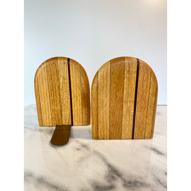 A sophisticated pair of handcrafted bookends featuring a soft, radiused "tombstone" silhouette. Constructed from solid...