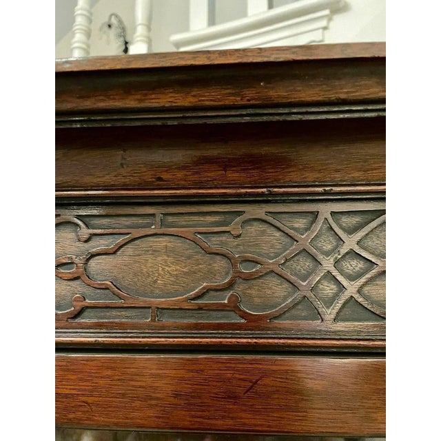 Quality antique Edwardian mahogany corner display cabinet having a shaped moulded cornice, blind fret carved frieze above...