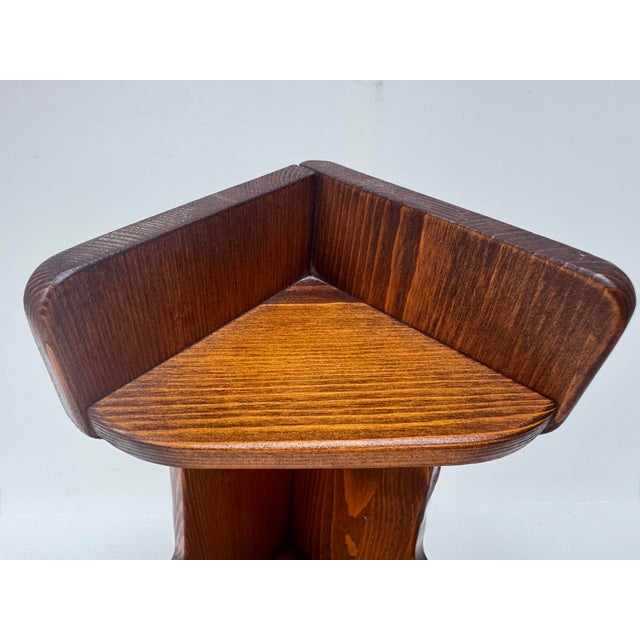 Vintage wood corner shelf with a distinctive two-tier design, curved side profile, and rich dark brown finish. Constructed...