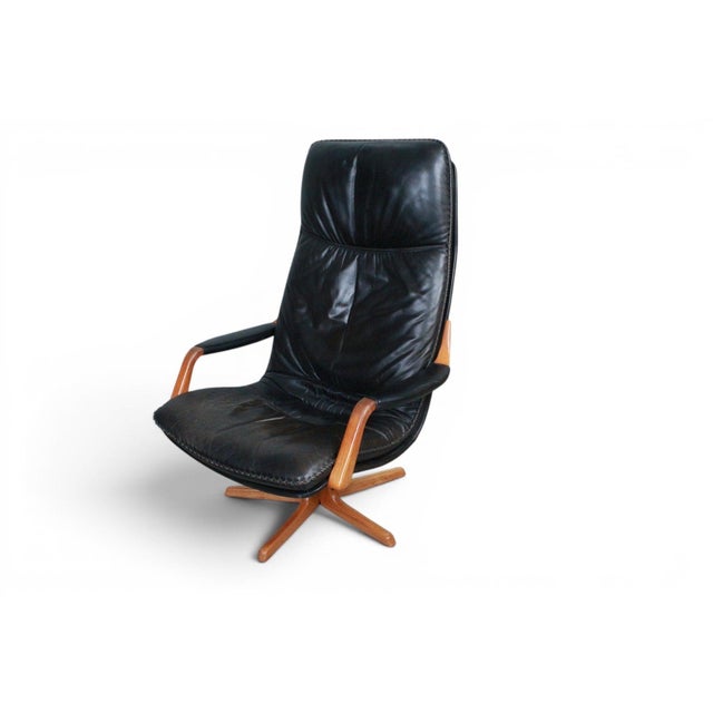 An imposing and exceptionally well-preserved 1970s highback swivel lounge chair and matching ottoman by Arne Wahl Iversen...