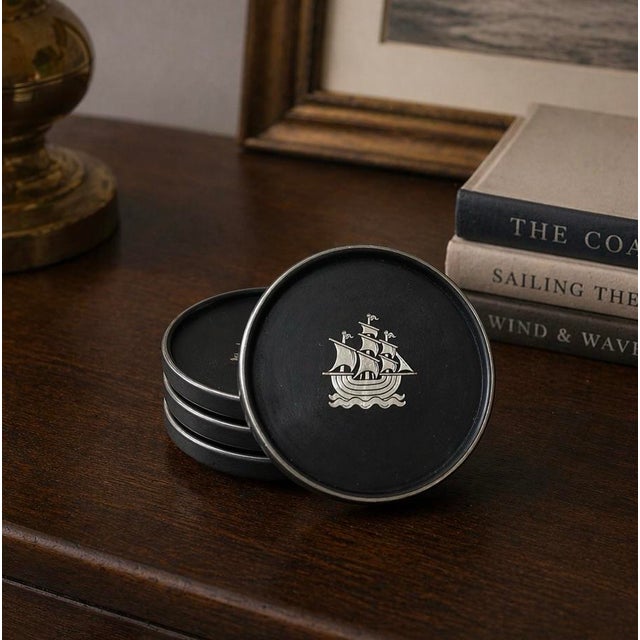 Vintage Swedish Lerstorp coasters crafted from black isolite-style compressed wood fiber with silver-tone sailing ship...