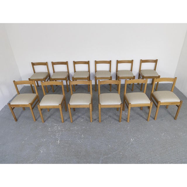 Set of 12 chairs with oak frame (signs of wear and tear) with seats with new fabric cover.