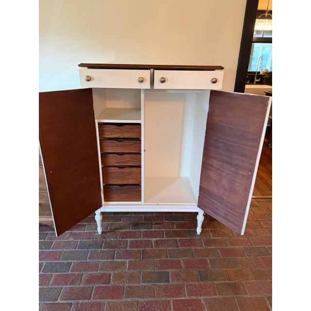 This charming vintage wood armoire combines classic traditional styling with an exceptionally functional fitted interior....