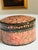 Vintage Kashmiri papier-mâché trinket box hand painted with an intricate floral composition on a dramatic jet-black...