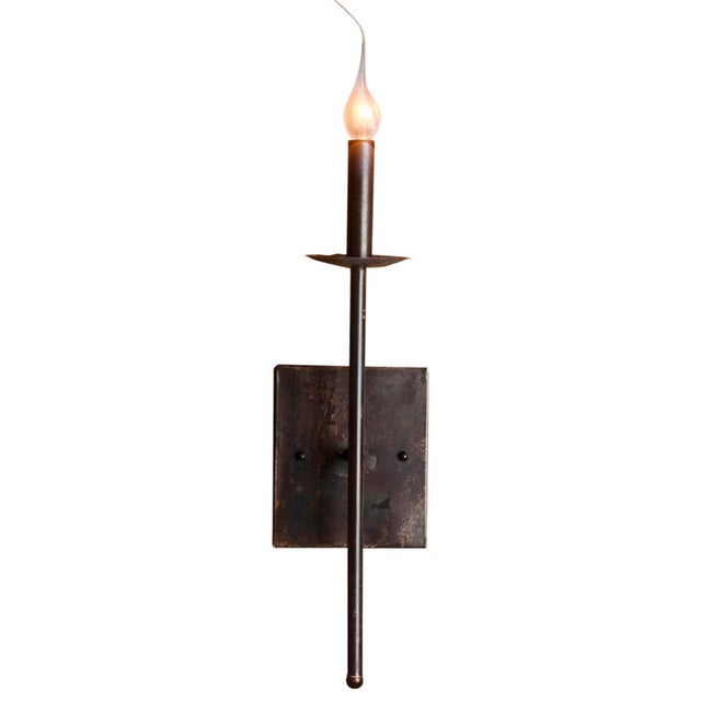 This single sconce is made of steel with a darkened bronze finish. This particular fixture works with both modern and...