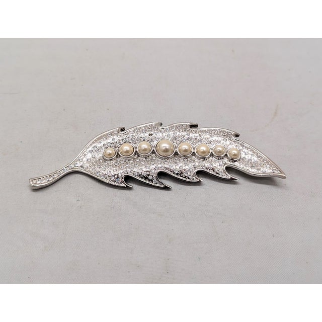 1980s rhodium-plated textured surface studded with round clear rhinestones with a line of faux-slightly off white pearls...