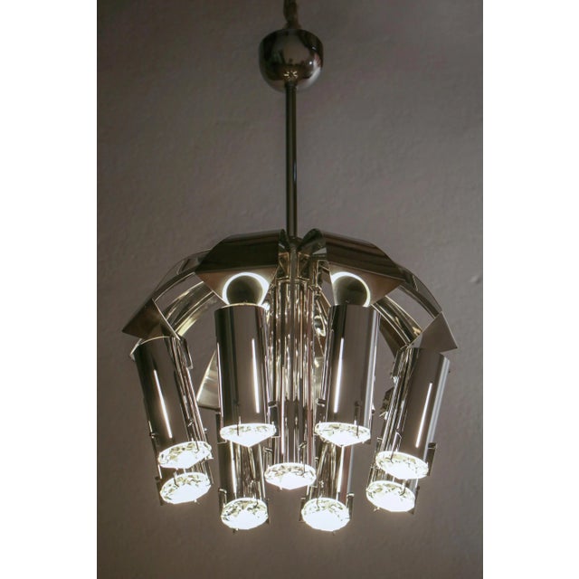 Wonderful chromed chandelier pendant ceiling lamp attributed to goffredo reggiani from the '70s. Structure made of chromed...