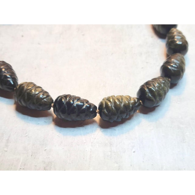 The necklace is 17.5 inches (44.5 cm) long, and the carved beads are approximately 25.5 x 15.5 mm. Each bead is expertly...