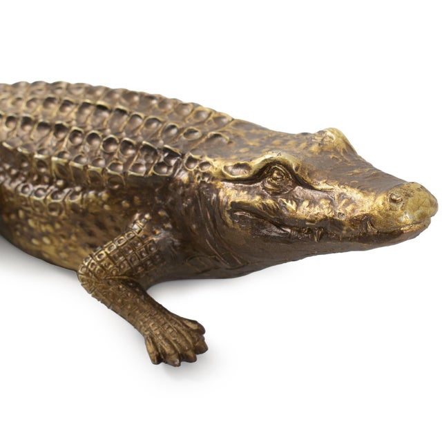 This Crocodile sculpture not only has a toothy grin, it has such detail, that if it weren't for the metallic brassy gold...