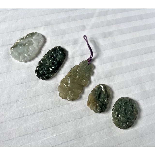 Set of 5 carved jade pendants. Each pendant is intricately carved. Birds on one side, foliage on the other. Each pendant...