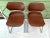 Pair of 1970s chrome stacker chairs featuring sculptural brown seats and clean architectural lines, a classic mid-century...