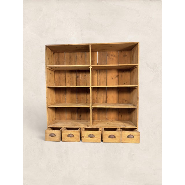 A charming antique English pine open bookcase, circa 1900, with a warm honey-toned finish, practical open shelving, and...